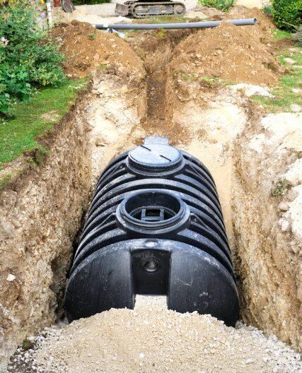 New septic tank being installed in an excavated trench in Troutman, NC